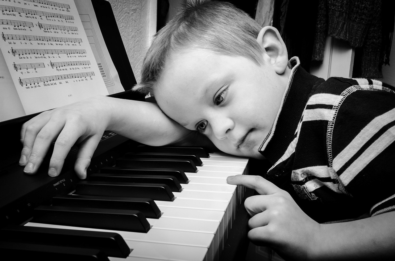 Sad kid at piano